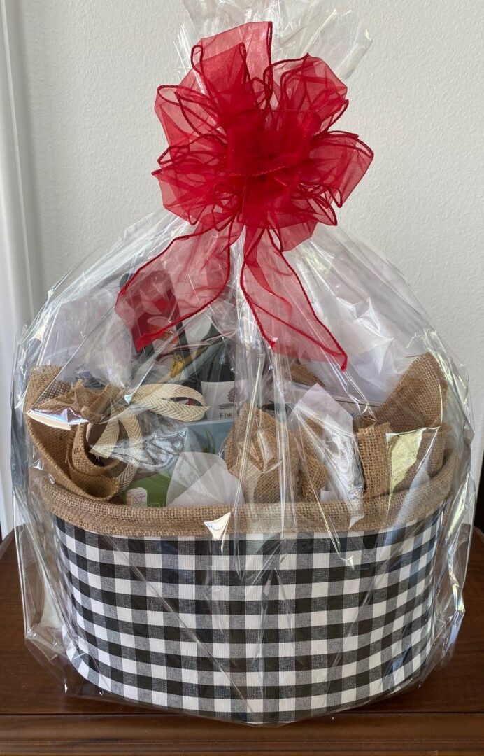 A gift bag with a red ribbon