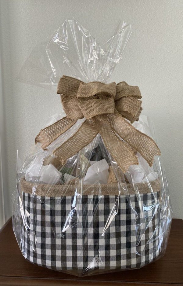 Gift bag wrapped in a plastic sheet with brown color ribbon