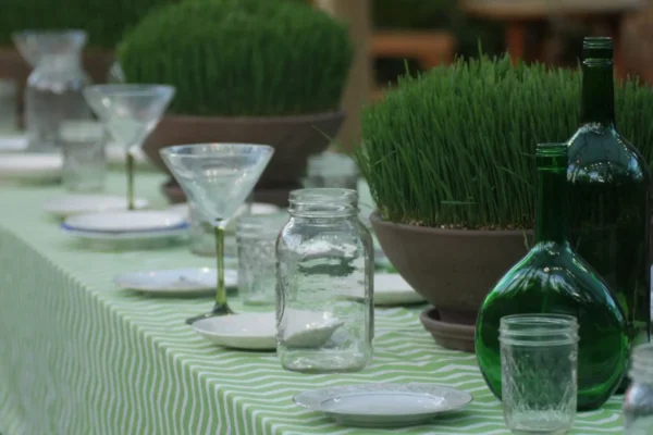 A table set with glasses and jars